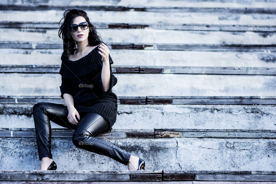 Portrait of a beautiful woman sitting on staircase