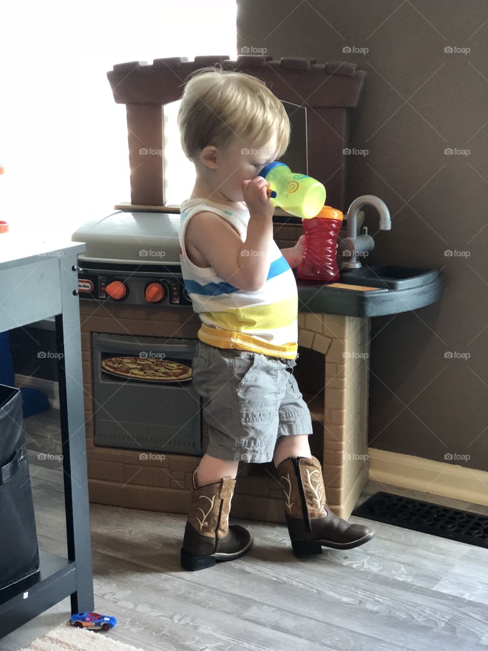 My son and his favorite boots, two drinks and working the grill like a pro!