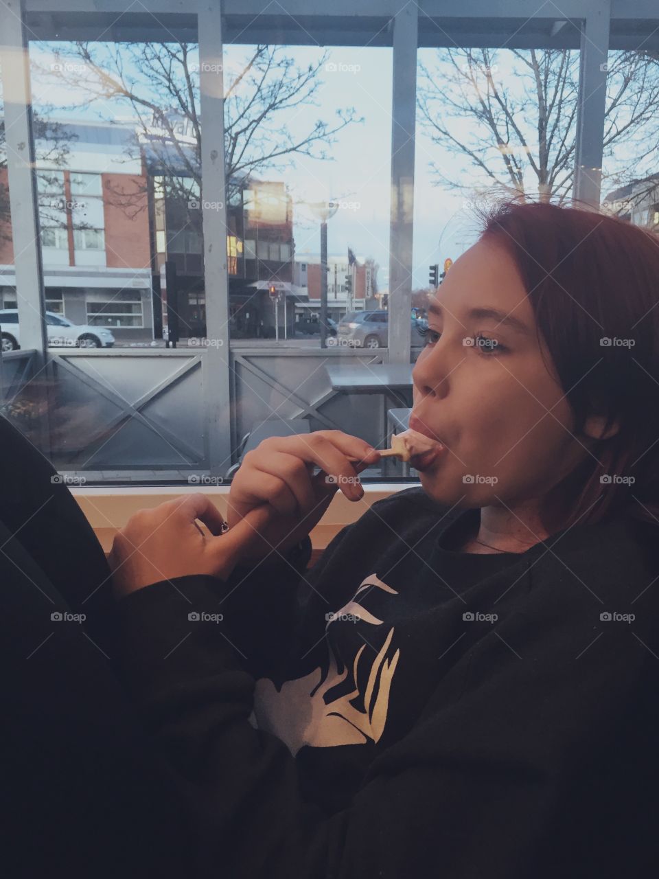 Girl eating ice cream at resteraunt