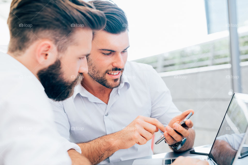 Two business men handsome working using smartphone - planning, connection, corporate concept