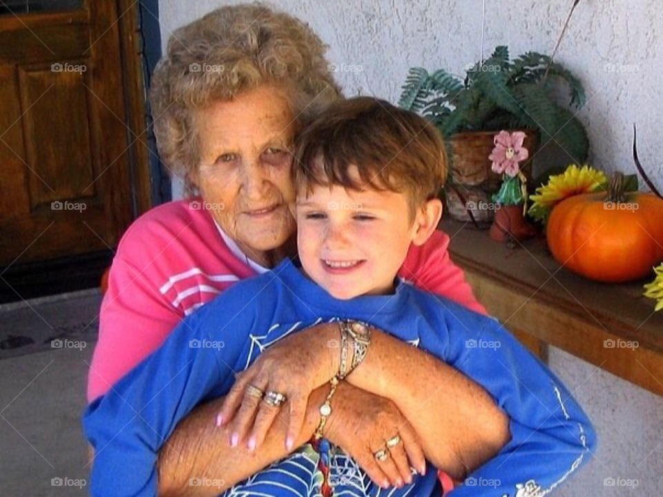 Grandmother hugging grandson. 