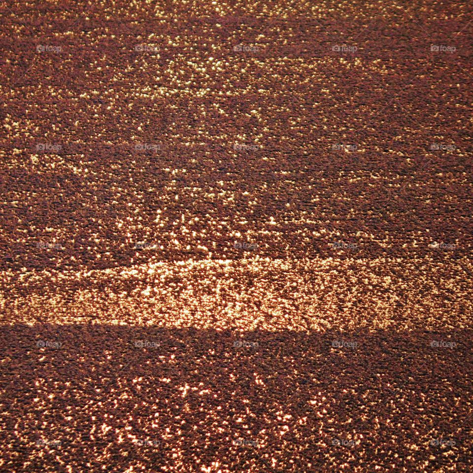 Sunset that's reflecting off frozen lake. 