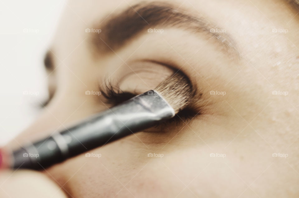Woman putting makeup on 