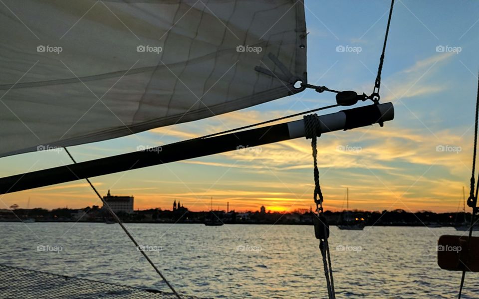 sailing at sunset on the coast