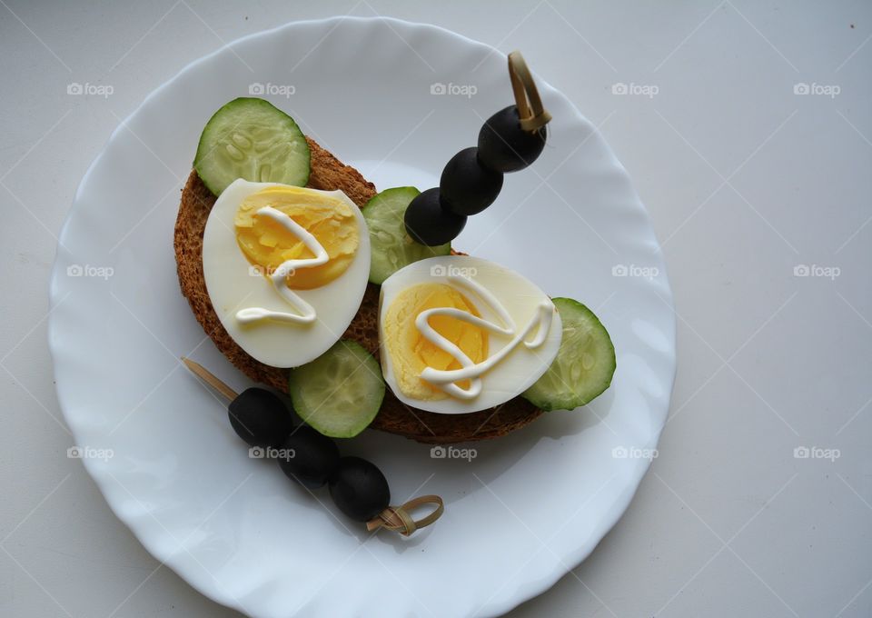 sandwiches with eggs and vegetables on a plate