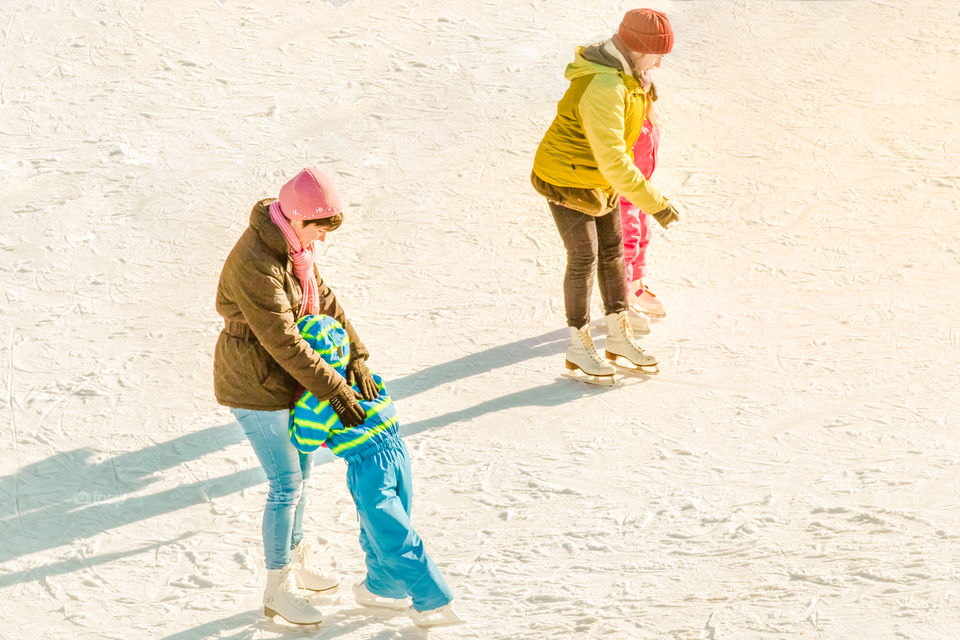 Mothers And Children Ice Skating
