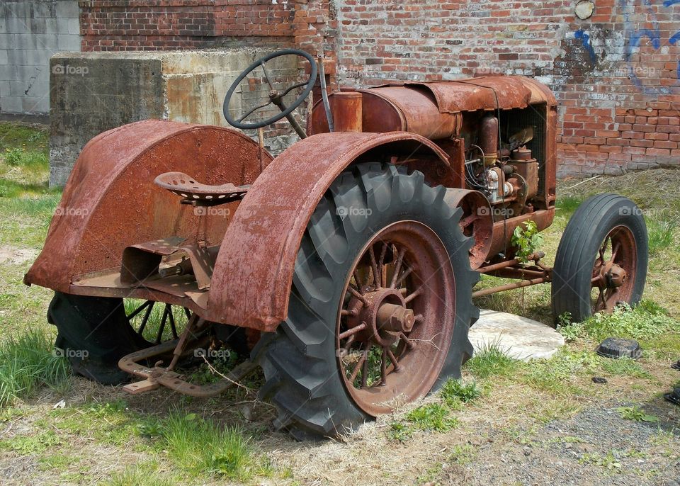 Rolling Rust. An abandoned tractor in a industrial park.