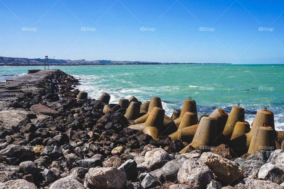 Dolos and beautiful sea green water at the Oamaru Breakwater, New Zealand 