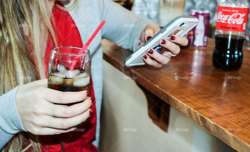 CocaCola- sitting and browsing social media with a CocaCola.