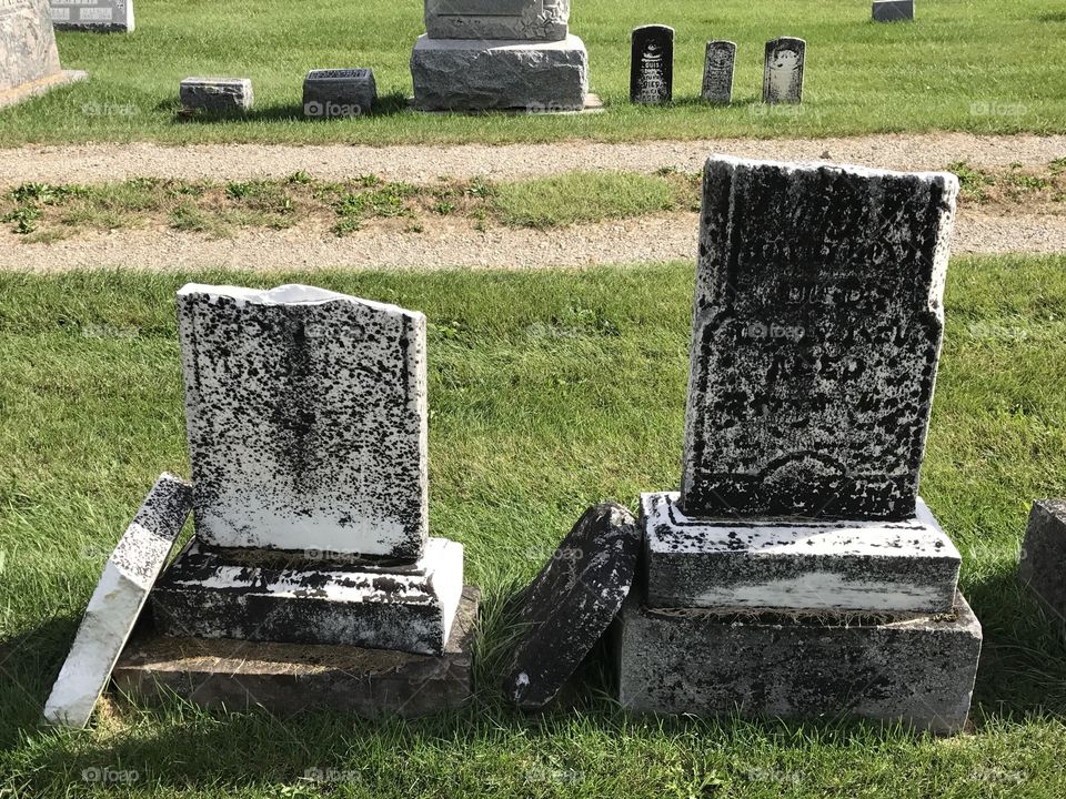 Two very old broken tombstones