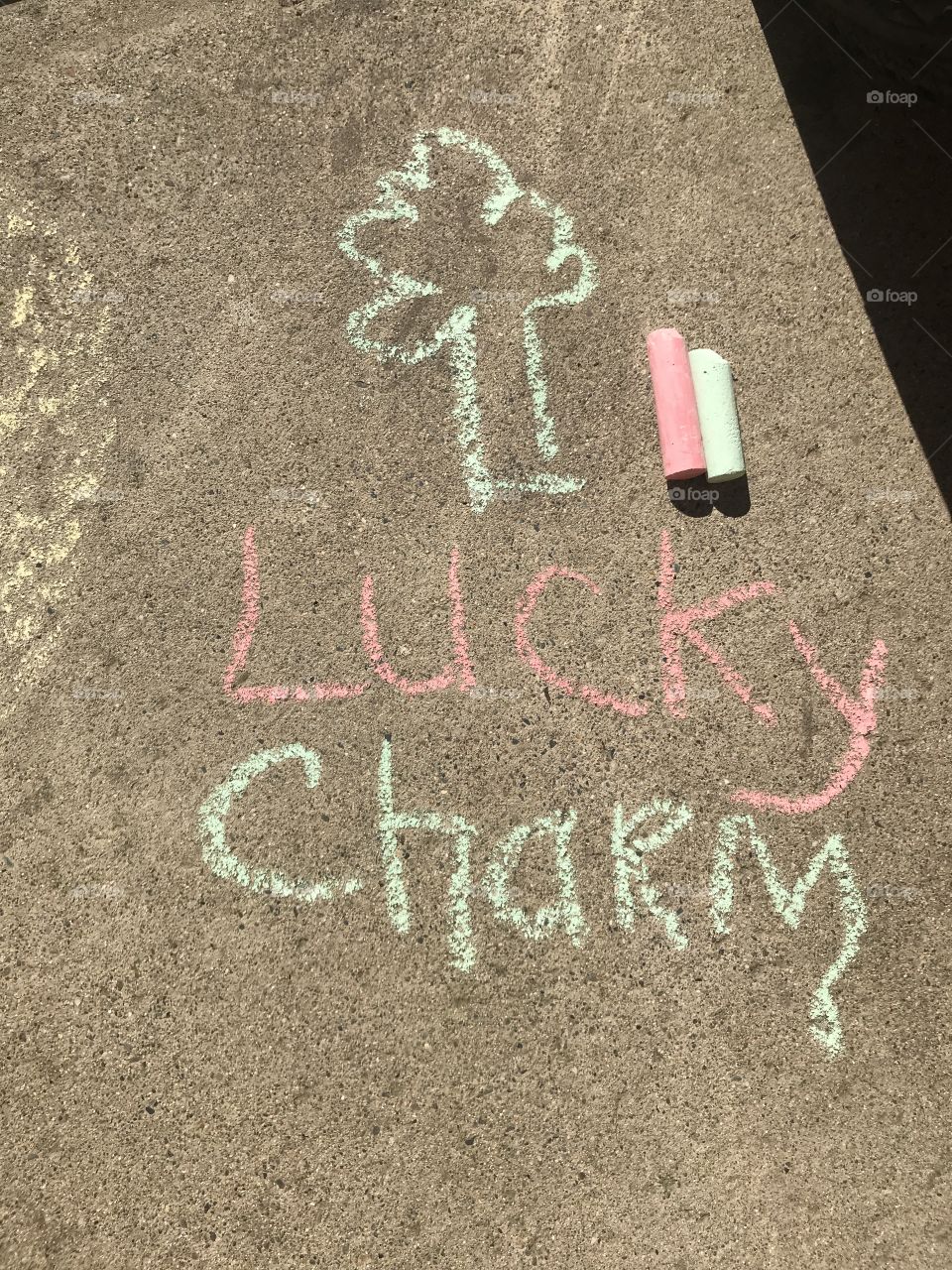 Shamrock Lucky charm drawn on the side walk with red and green sidewalk chalk located in the USA, America 