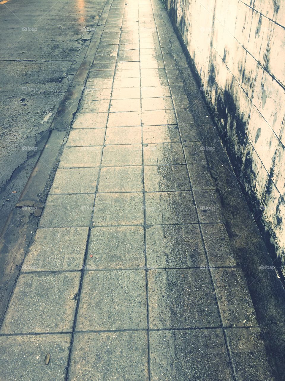 Beautiful drop water and wall shadows on street.