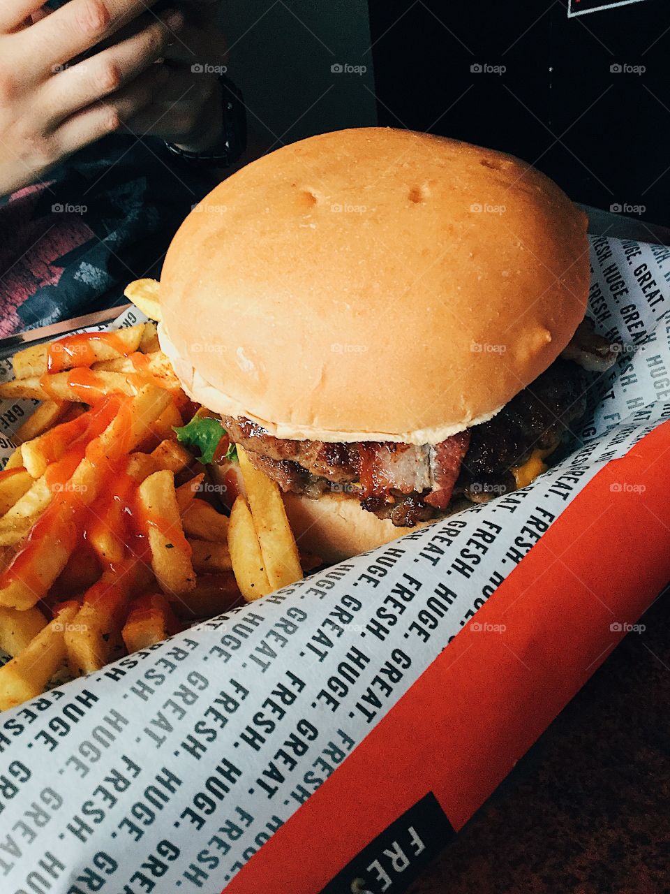 Burger with french fries on the side.