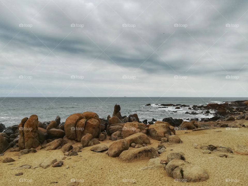 beach with yellow pebbles in Vila Nova de Gaia overlooking the Atlantic Ocean (Portugal)