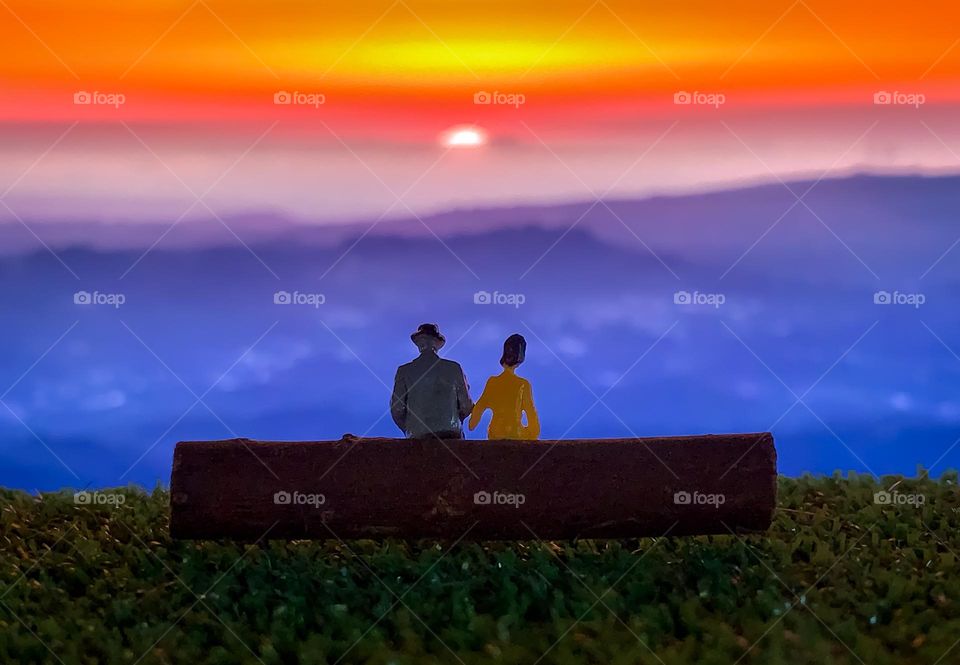 Happiness is watching the sunset with someone special - scene created with 2 miniature figures seated in front of a sunset picture I took displayed on a screen