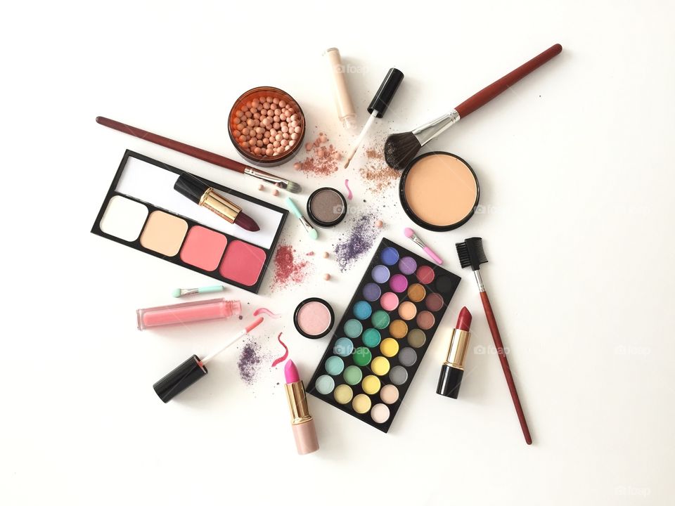 Makeup cosmetics flat lay on white background