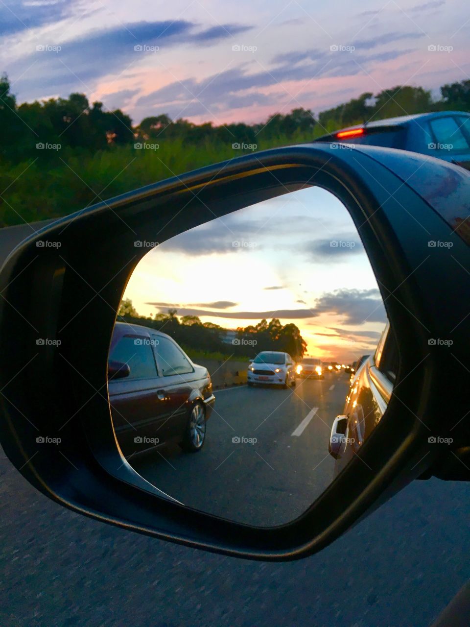 On the road, through the rearview of the car, we see this beautiful landscape in the interior of Brazil.