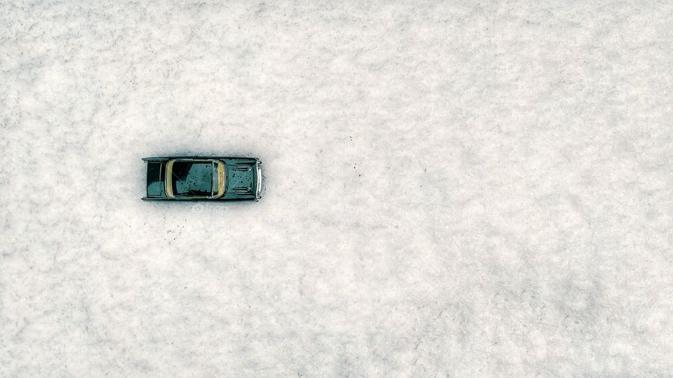 A classic car hidden in snow
