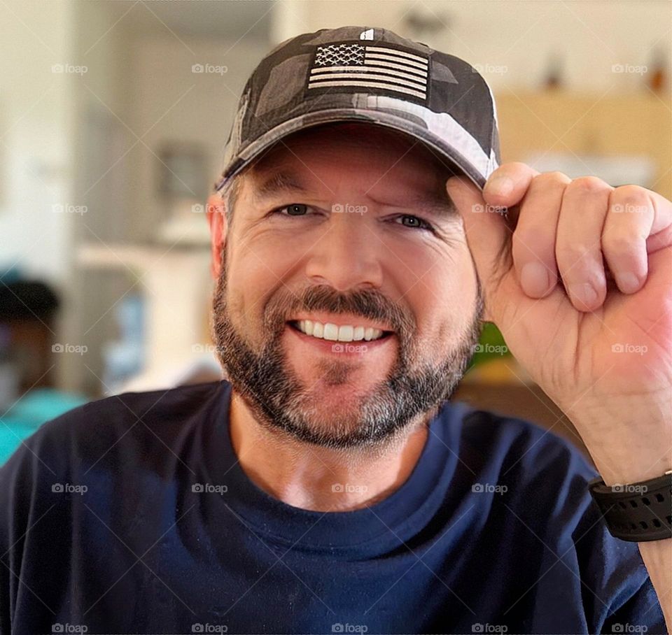 Handsome mustached man in a cap.