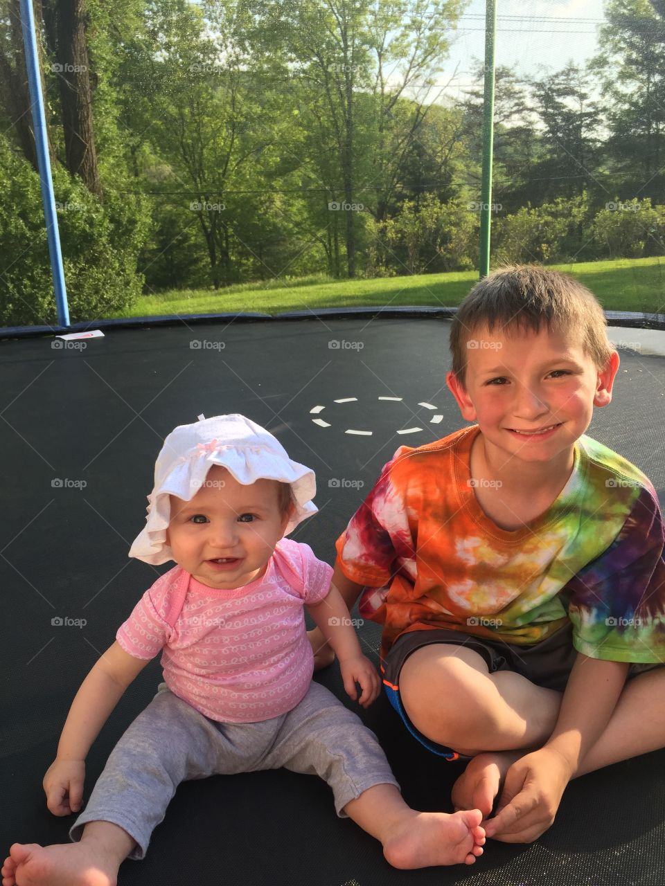 Fun in the sun. Kids on a trampoline 