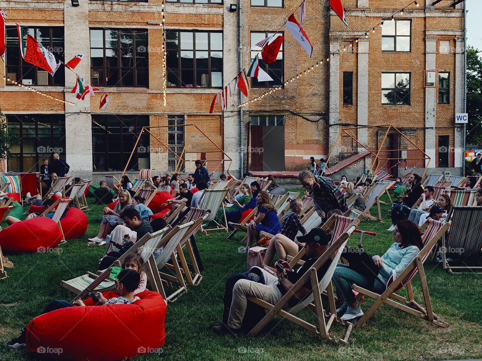 People relaxing on the chairs on music festival