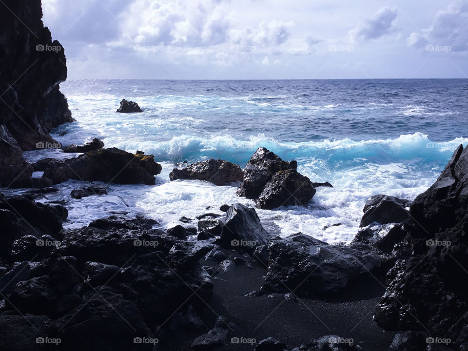 Sunny day on the ocean and lava rock