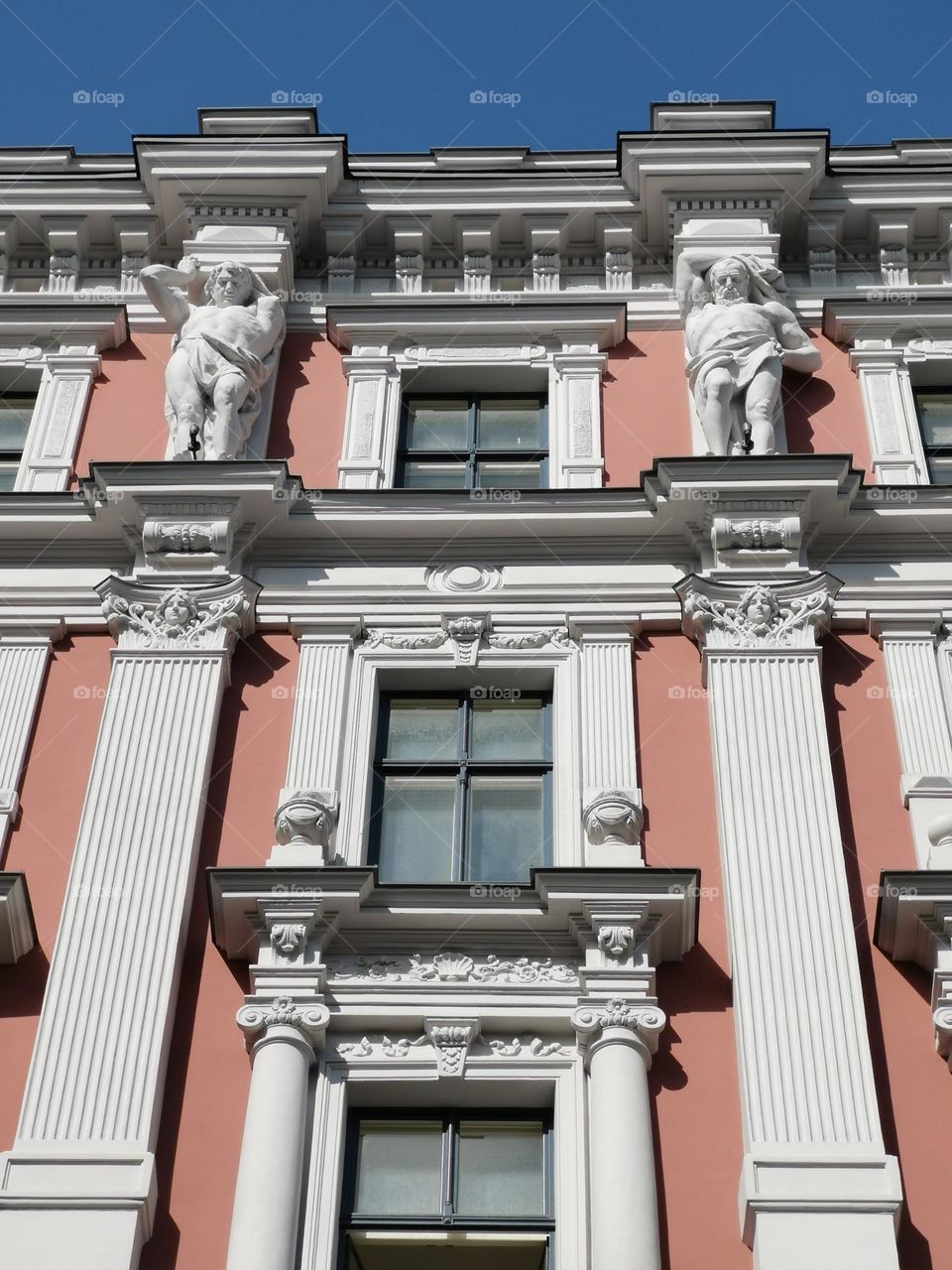 Architecture. Mobile streetphoto. Riga, Latvia. Building. Windows. Sculptures.