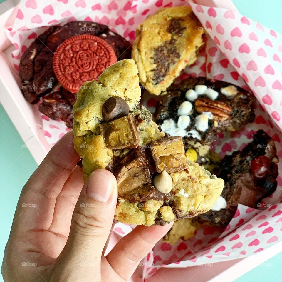 Freshly baked Gooey Easter cookies in chocolate in big chunk with hot tea for afternoon snack 