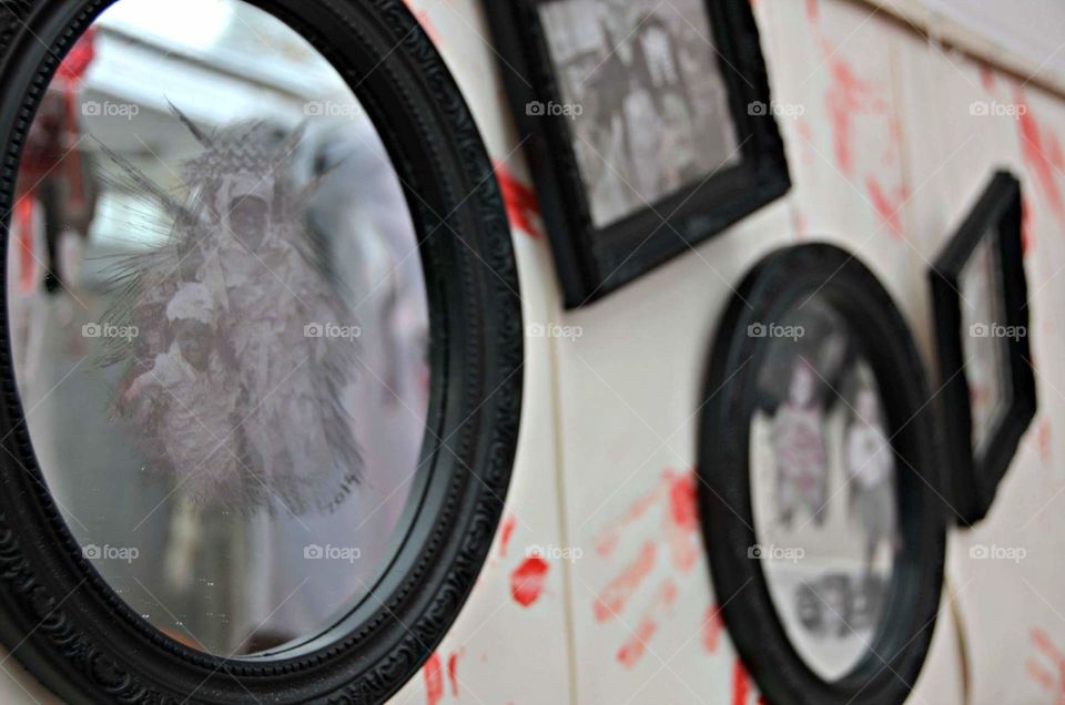 bloody wall paper with haunted mirrors hanging