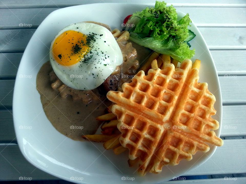 Grilled chicken with waffle on plate