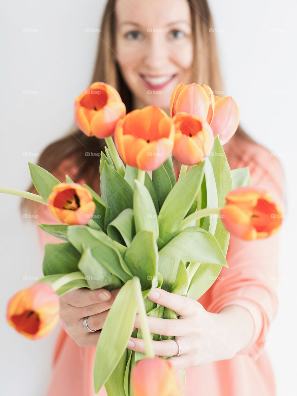 Orange tulips holder by a girl 