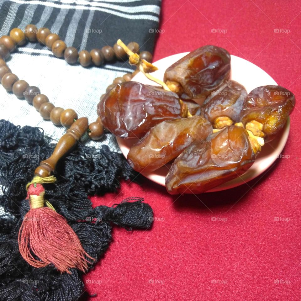 Date palm fruit on red background