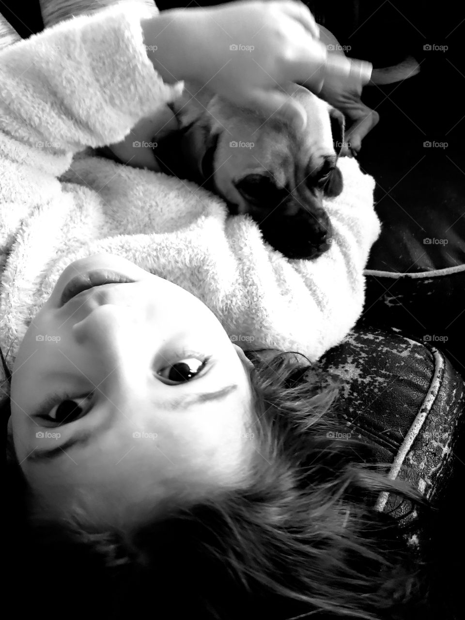 child and her dog cuddling