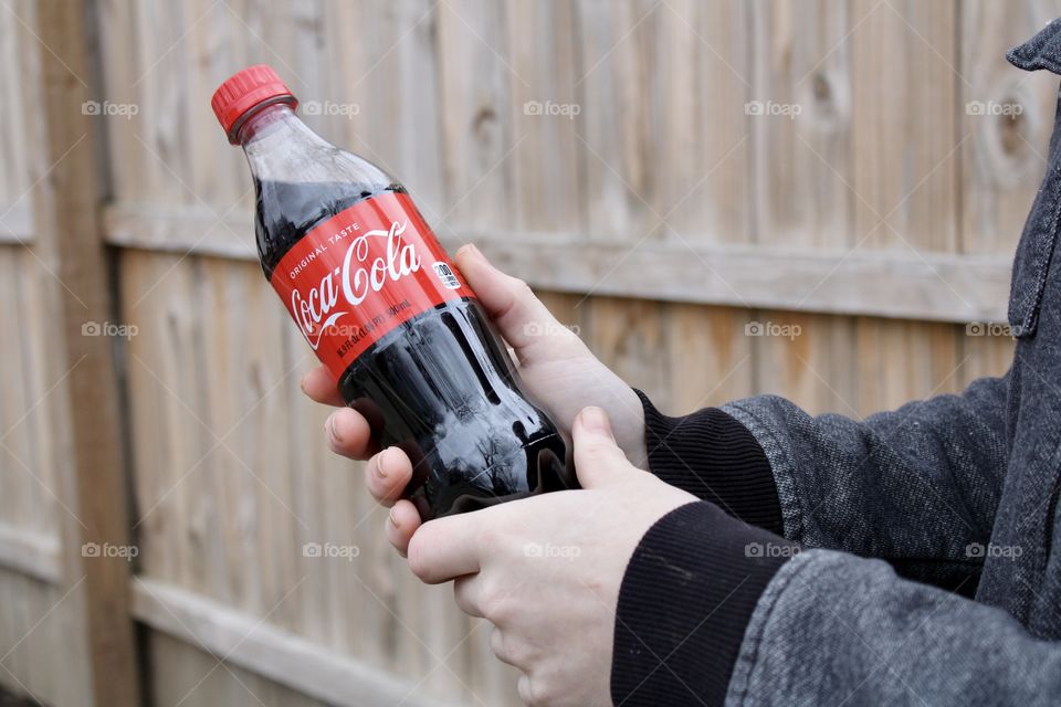 Holding a Bottle of Coca Cola Close Up