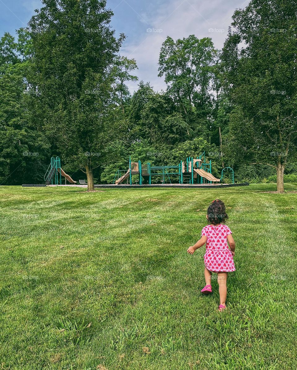 Toddler girl walking to playground in summer dress, summertime outfits, strawberry summer dress on toddler girl, at the park with a toddler girl