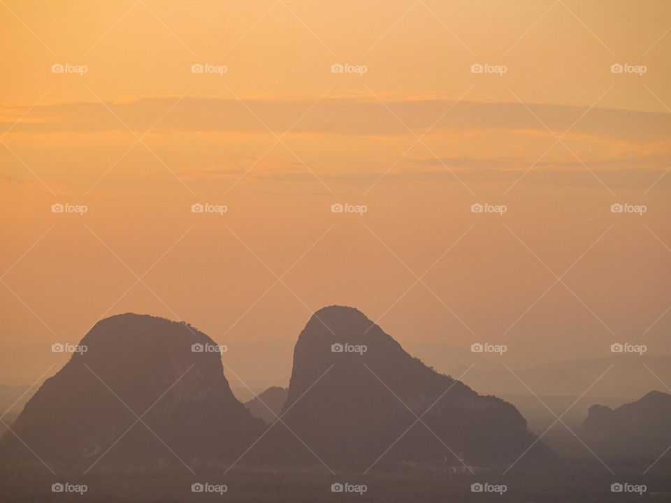 Mountains view at sunrise. Fog covering the mountains