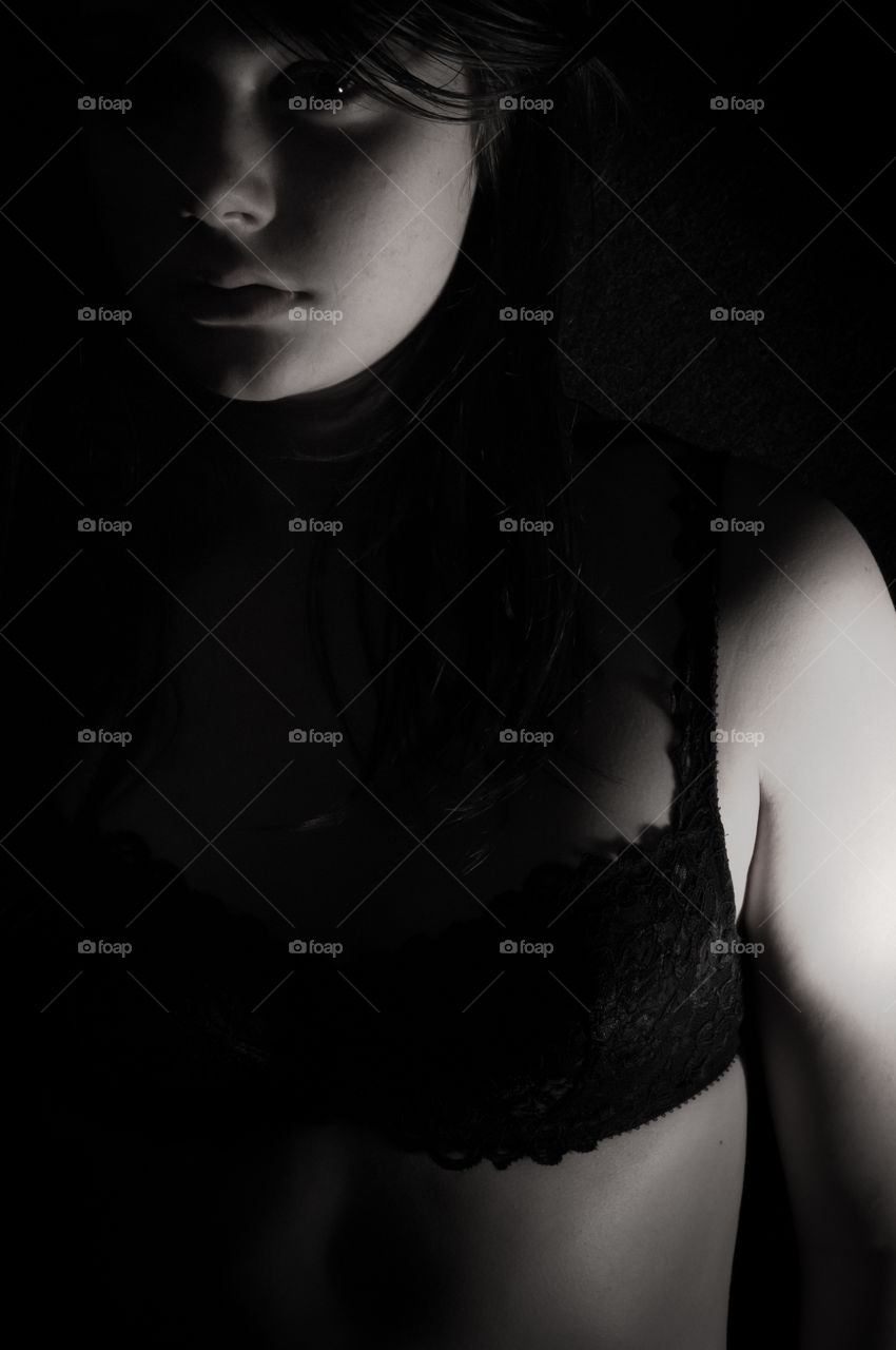Teenage girl in lingerie with black background