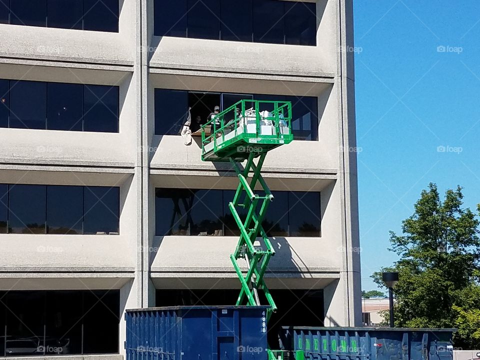 Contractors remove garbage from an office building.