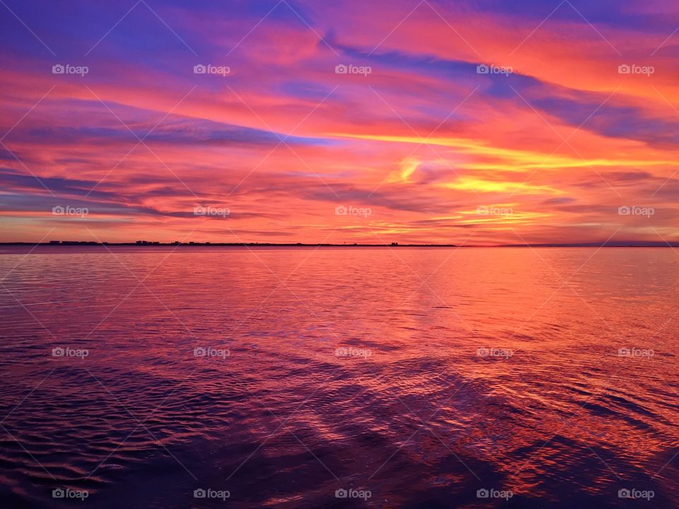 
Sun setting, and I thought I’d seen them all, and this one came along -Bright streaks of red, pink, and orange slowly overcame the dark blue and purple of the twilight sky. The sky resembled a prism; all the colors blended perfectly into each other