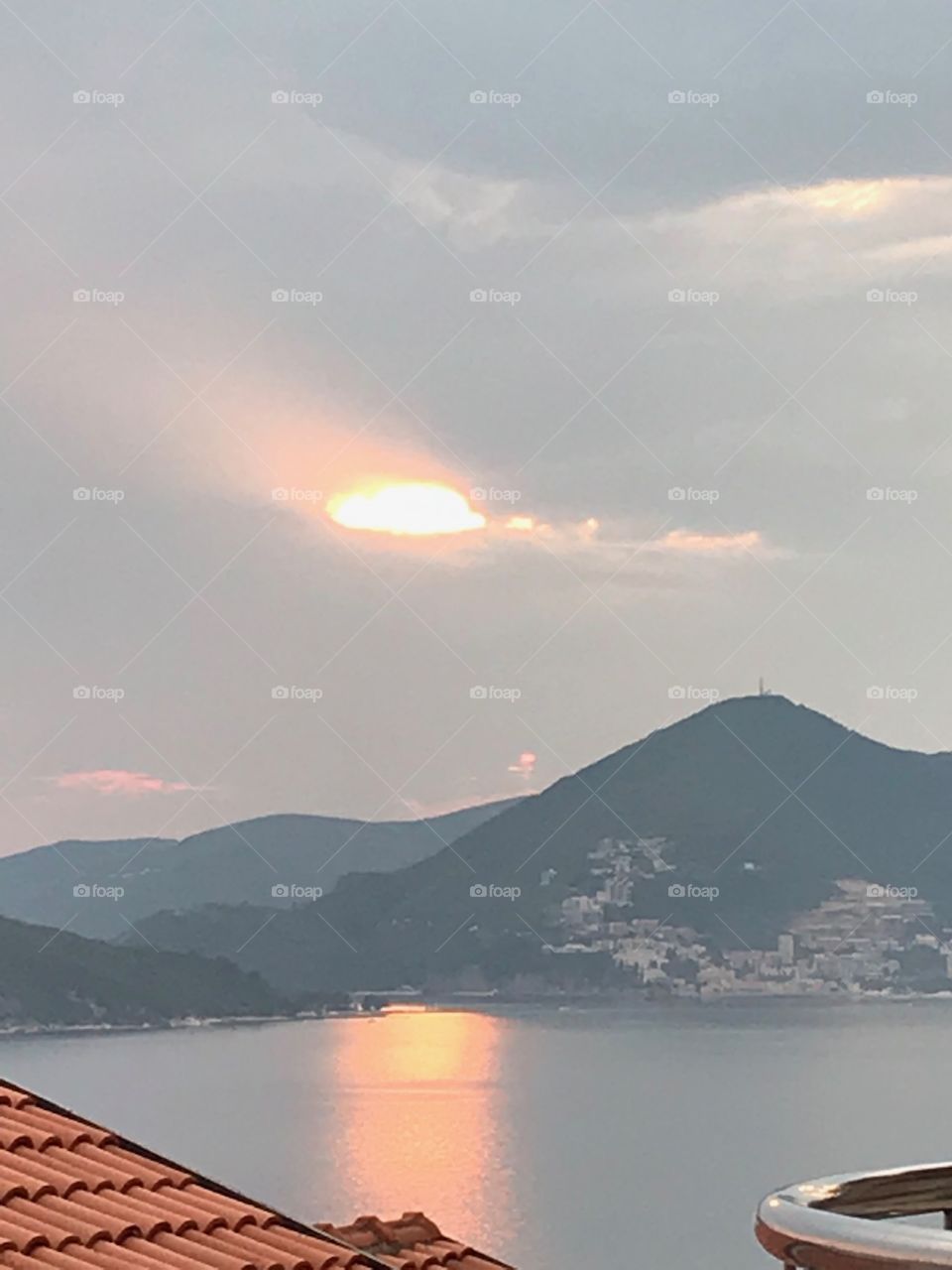 Divine and Magical Sunset at Montenegro , rays of Sun bursting behind clouds above St.Stephan.