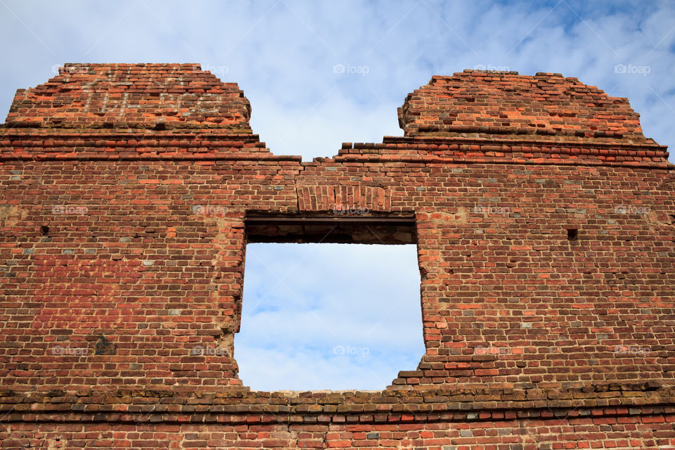 window in an old destroyed brick building