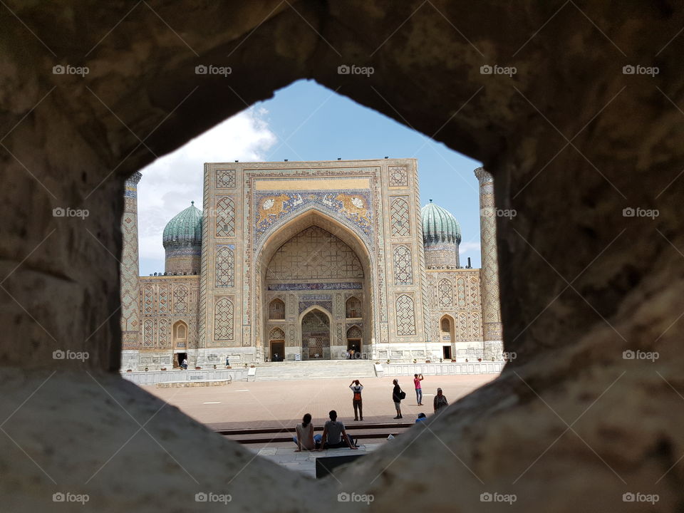 View through hexagonal opening on madrassa on the Registan in Samarkand in Uzbekistan, pearl on the Silk road.