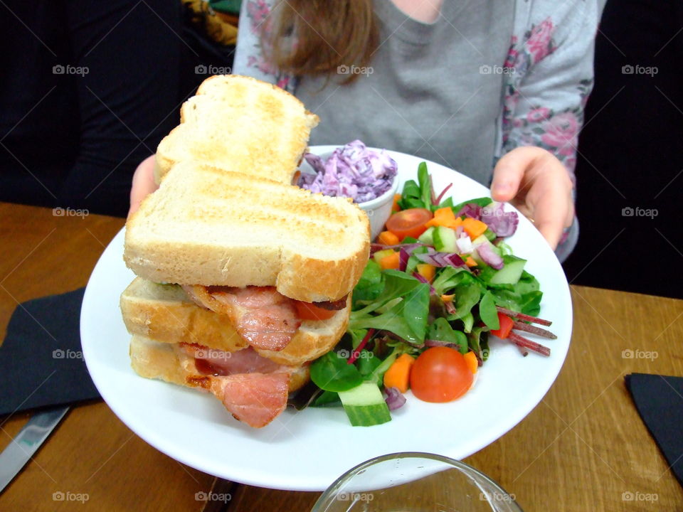 BLT sandwich, salad, and purple Cole slaw on large, white plate