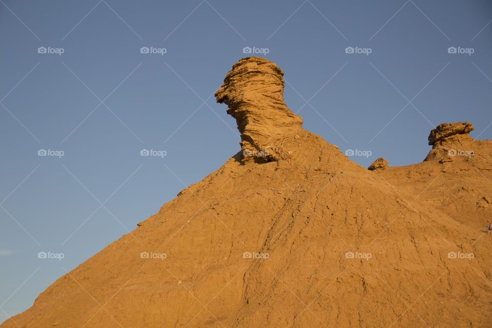 Mountain against the blue sky in the Sahara desert.