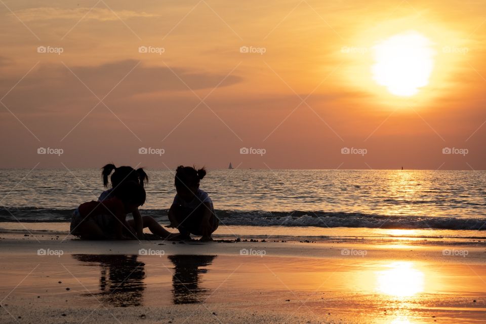 Three sister play on the beach in beautiful sunset moment