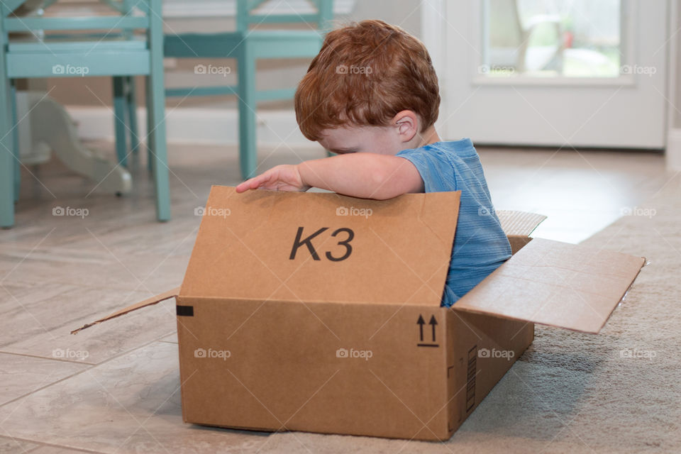 Boy playing in a box 