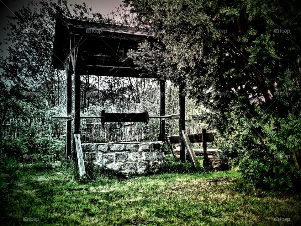 the source. a well with handwheel an roof