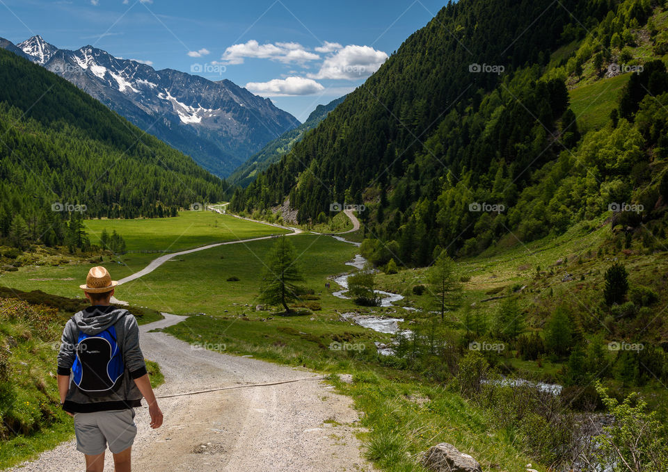 Young man on walking path in the Ahrntaler alps, South Tyrol