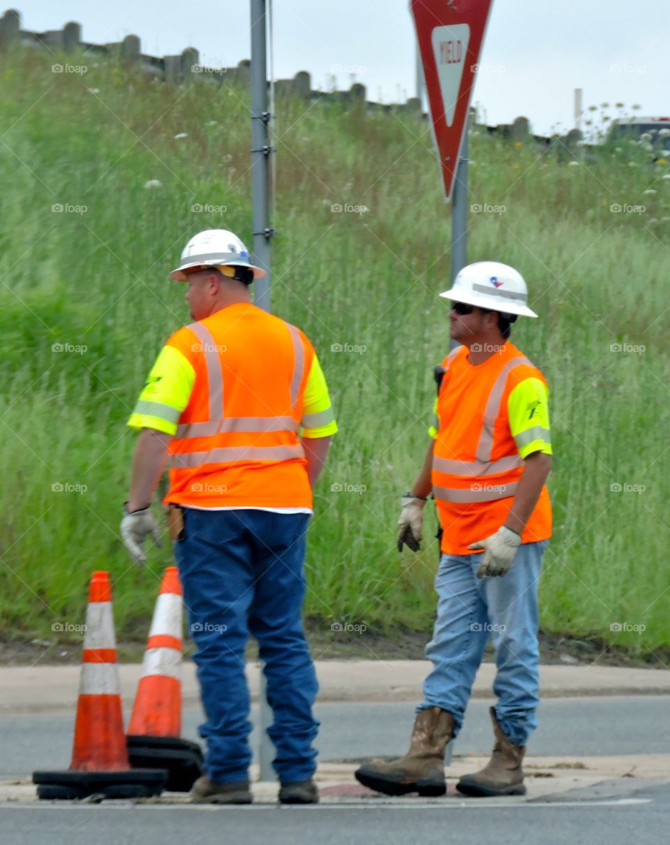 Construction workers. Guys working on construction by a highway