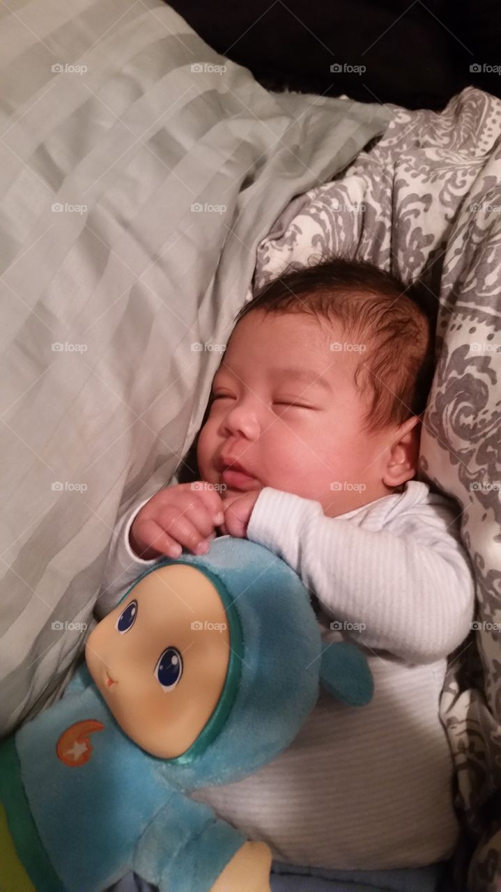 newborn sleeping with glo worm